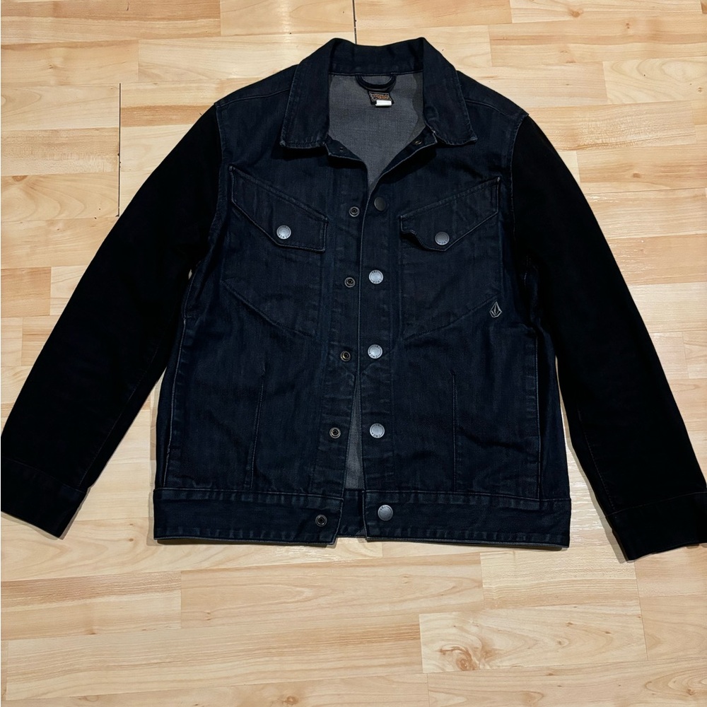 Dark wash volcom denim jean jacket with contrast sleeves and snap buttons